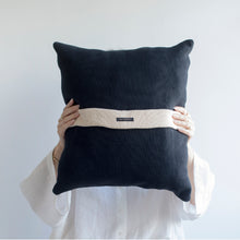 Load image into Gallery viewer, Add a little bit of style and personality to your home with the X cushion. By playing with the negative spaces to create a unique feeling, the X cushion offers timeless aesthetic with a bold repetitive pattern.  Disclaimer: Every cushion is individually knitted and sewn by hand to ensure the highest level of comfort and long-lasting quality, which means you may find slight variations in design and size.  Cushion filling included. 42 x 42 cm 100% polyester