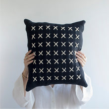 Load image into Gallery viewer,  Add a little bit of style and personality to your home with the X cushion. By playing with the negative spaces to create a unique feeling, the X cushion offers timeless aesthetic with a bold repetitive pattern.  Disclaimer: Every cushion is individually knitted and sewn by hand to ensure the highest level of comfort and long-lasting quality, which means you may find slight variations in design and size.  Cushion filling included. 42 x 42 cm 100% polyester
