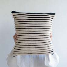 Load image into Gallery viewer, Our striped cushion is not like any other striped cushion. Thanks to special knitting techniques, three-dimensional fabric fold stripes are created.  Disclaimer: Every cushion is individually knitted and sewn by hand to ensure the highest level of comfort and long-lasting quality, which means you may find slight variations in design and size.  Cushion filling included. 43 x 43 cm 100% polyester
