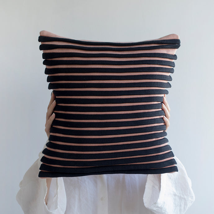 Our striped cushion is not like any other striped cushion. Thanks to special knitting techniques, three-dimensional fabric fold stripes are created.  Disclaimer: Every cushion is individually knitted and sewn by hand to ensure the highest level of comfort and long-lasting quality, which means you may find slight variations in design and size.  Cushion filling included. 43 x 43 cm 100% polyester