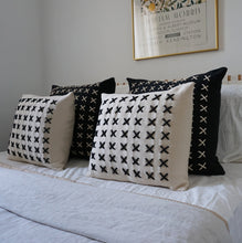 Load image into Gallery viewer, Add a little bit of style and personality to your home with the X cushion. By playing with the negative spaces to create a unique feeling, the X cushion offers timeless aesthetic with a bold repetitive pattern.  Disclaimer: Every cushion is individually knitted and sewn by hand to ensure the highest level of comfort and long-lasting quality, which means you may find slight variations in design and size.  Cushion filling included.  42 x 42 cm 100% polyester
